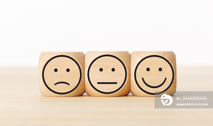 User service feedback, rating customer review, poll, satisfaction survey concept. Wooden blocks with facial expressions