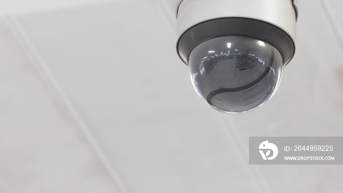 Dome type CCTV surveillance security camera install on ceiling to monitor the property to protect from crime. Secure control system that observe and record video for safety.