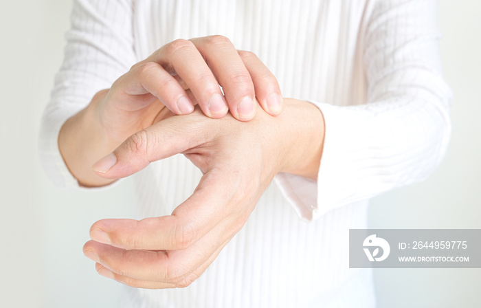 Man’s hand. He massaged his hand and had finger pain. Locked fingers from work and office syndrome on a white background medical concept