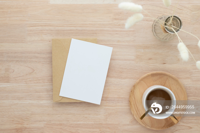 Blank paper cards, Blank greeting card invitation Mockup with Dried Bunny Tail grass in vase and coffee cup, wood desk background, Minimal wood table workplace composition, flat lay, mockup