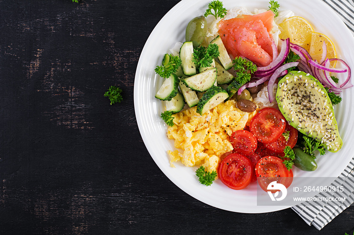 Salt salmon salad with tomatoes, cucumbers, scrambled eggs and avocado. Ketogenic diet breakfast. Keto lunch. Top view, overhead