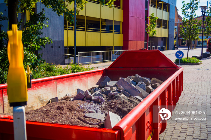 container in the city with construction debris