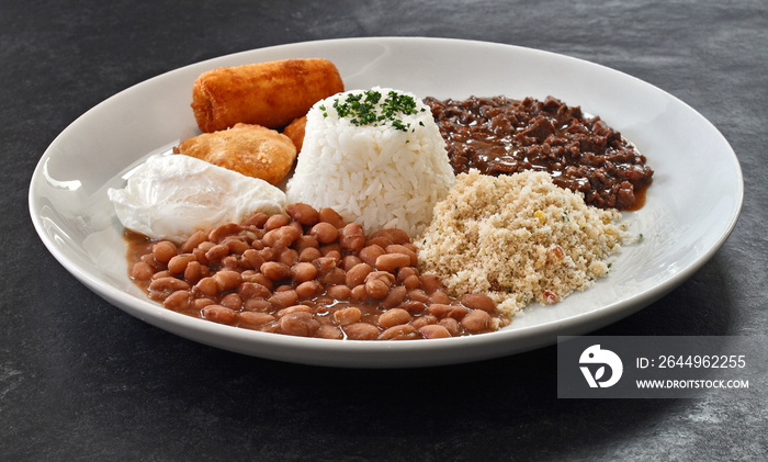 Picadinho, typical Brazilian dish with meat, rice, beans, farofa, banana, pastries and fried egg