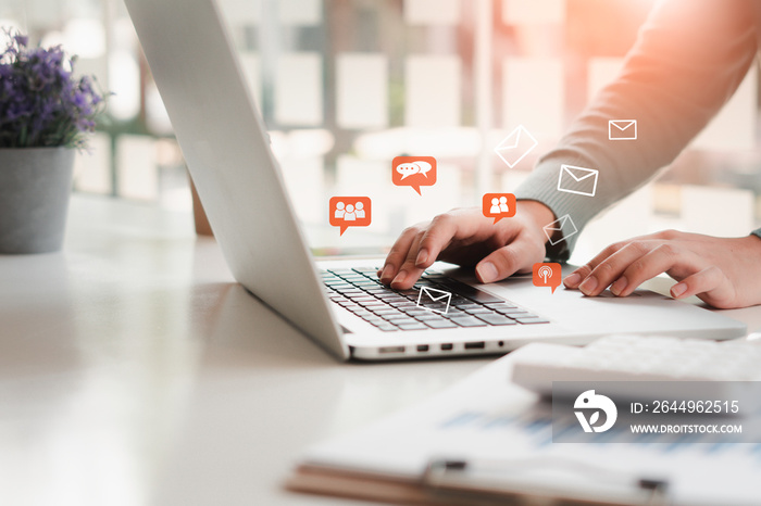 Young woman’s hand is using a computer laptop to play social media, notification icon ,Social Distancing ,Working From Home concept.