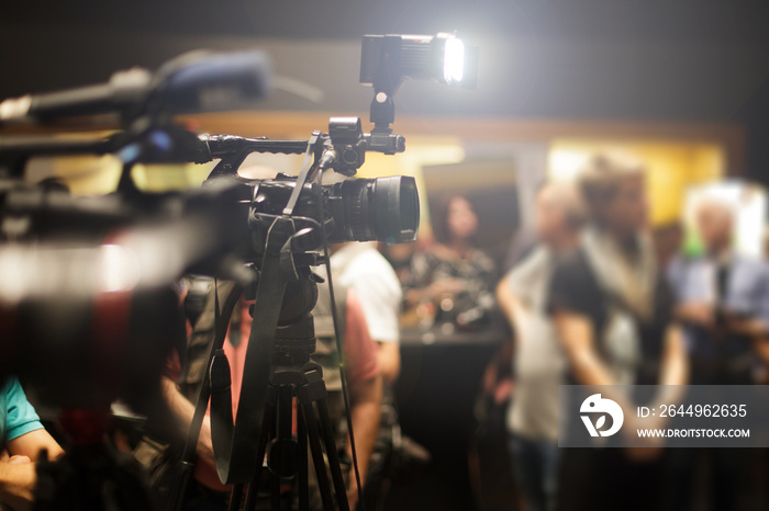 press and cameras recording a conference event