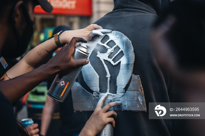 Protesters painting Black Lives Matter sign