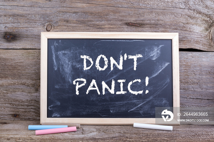 DON’T PANIC! Text on blackboard