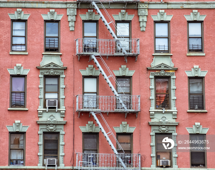 Red brick facade, and fire stairs. Harlem, NYC.