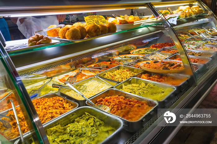 Various type of pastas, sauces and rice balls cooked and sell on aluminum tray  at the market, Mercato di San Lorenzo, in Florence, Italy