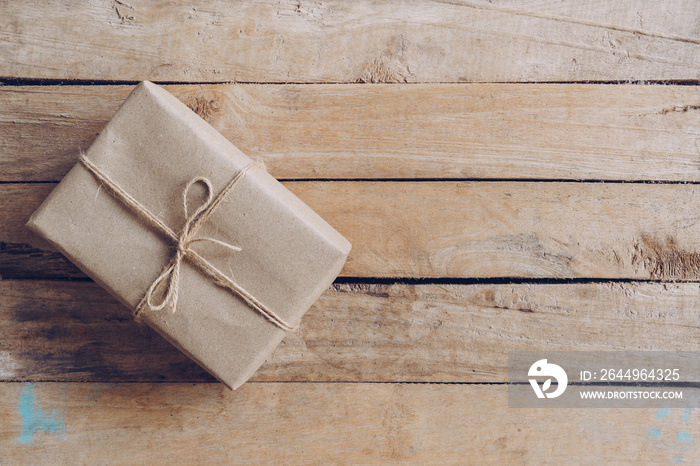 Above brown gift box on wooden table background with copy space.