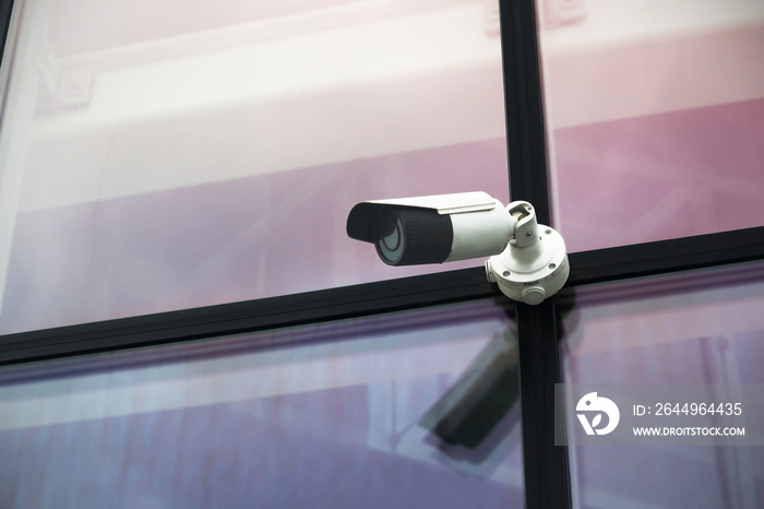 Outdoor video security camera on glass wall