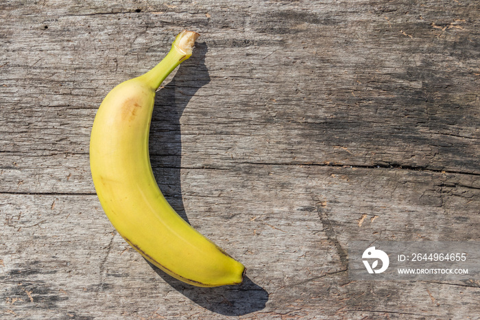 Delicious ripe yellow banana fruit on rustic wooden table