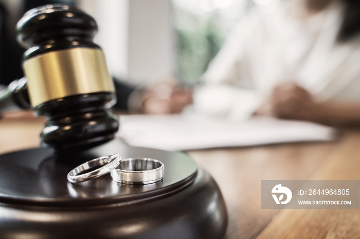 Judge gavel with pair of marriage ring, Divorce concept.