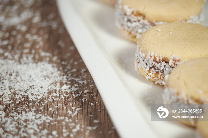 Delicious Argentinian cookies cornflow alfajores with cream dulce de leche close-up isolated. White vanilla macaroons on white background. French delicate dessert for Breakfast.