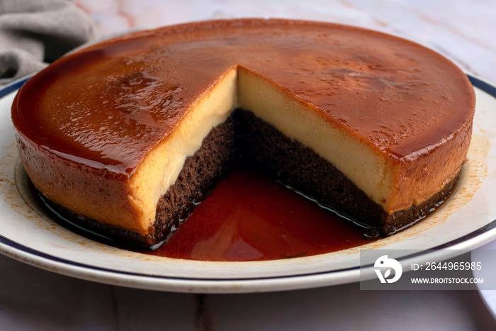 inverted cake chocoflan flan with chocolate sponge cake with cream delicious sweet dessert on counter