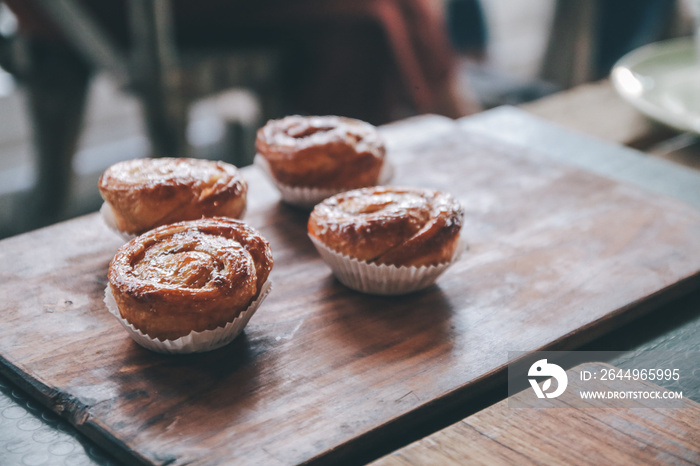 Kouign amann: Croissants on wooden background in restaurant, breakfast pastries, french pastries.