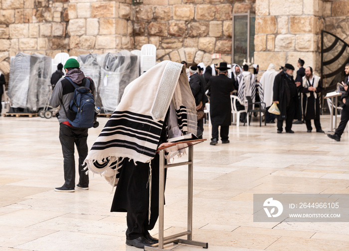 Believer Orthodox Jew prays near the Kotel in the Old Town of Jerusalem in Israel