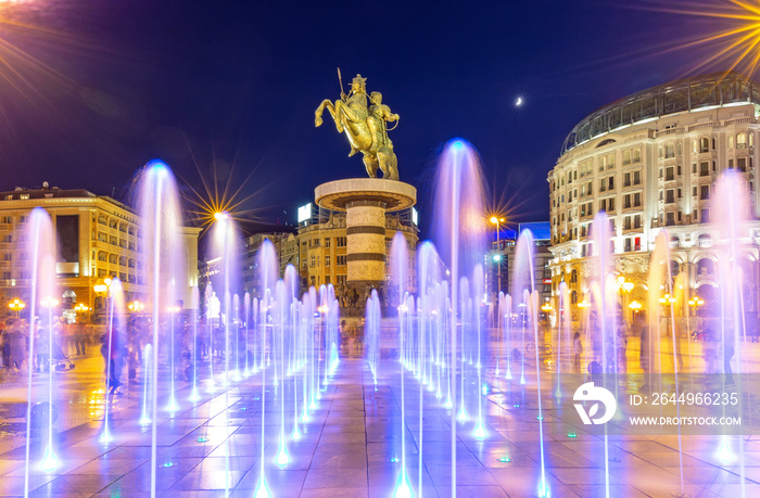 Square Macedonia in Skopje at night with dancing illuminated fountains and statue of Alexander the Great (warrior on horse) at background