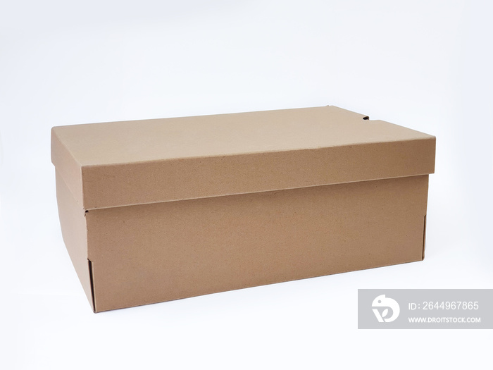 Brown cardboard shoes box with lid for shoe or sneaker product packaging mockup, isolated on white background with clipping path. Craft paper box. Front view.