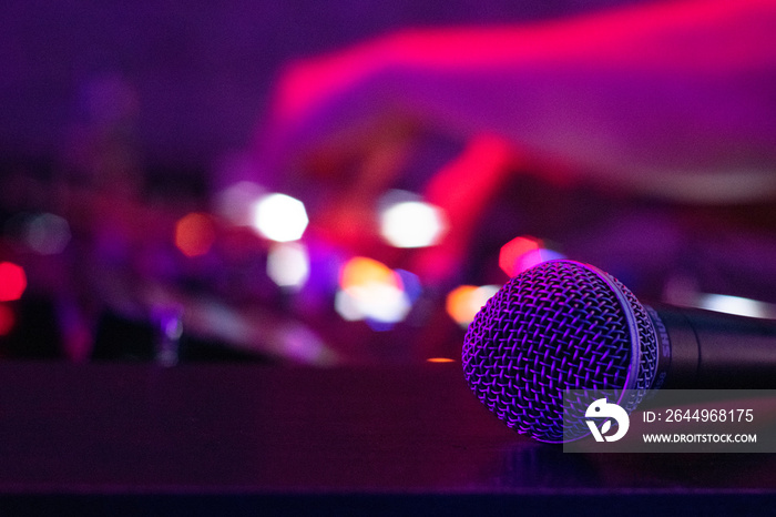 A microphone rests on a desk as a DJ works the turn tables at a night club in downtown Austin, TX.