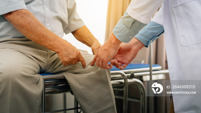 senior man has knee pain problem Elderly grandfather visiting male doctor to check up health problems and consulting way to protect suffering from knee