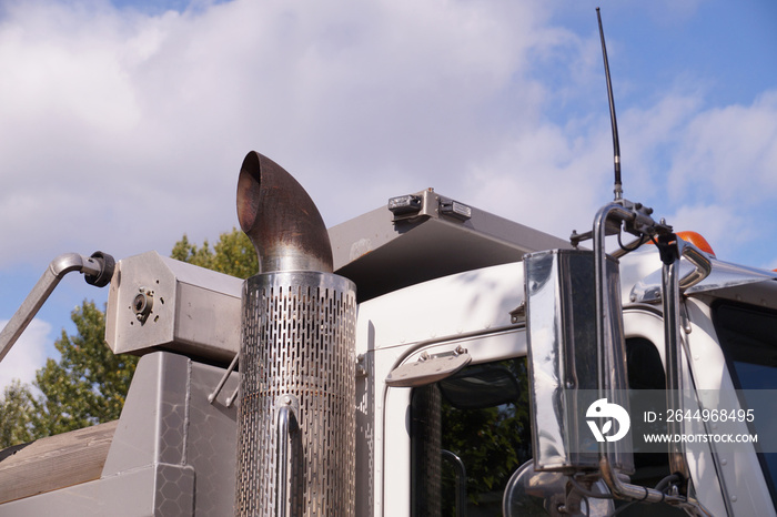 Close-up of a truck cab. Exhaust pipe visible.