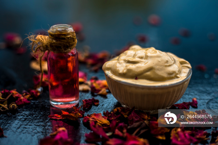 Ubtan/face mask/face pack of Multani mitti or fuller’s earth on wooden surface in a glass bowl consisting of Multani mitti and rose water for the remedy or treatment of oily skin.On wooden surface.