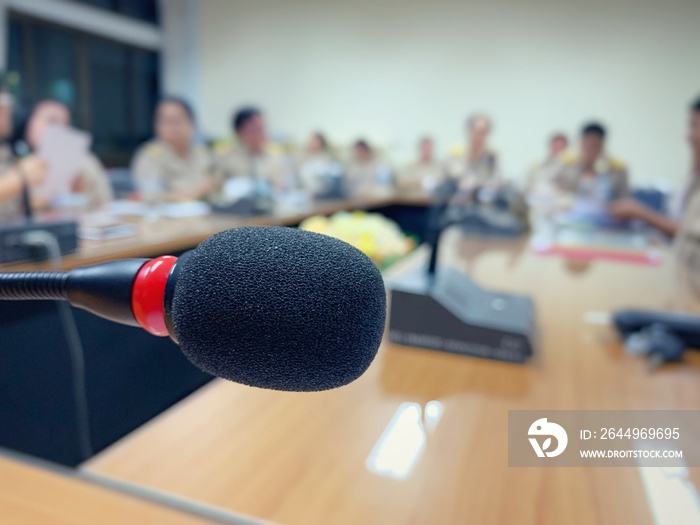 The microphone has a background as a meeting of teachers and administrators in the meeting room in Thai schools.