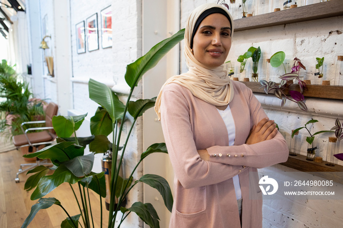 Portrait of woman wearing headscarf in flower shop