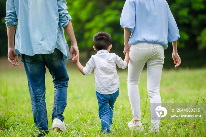 young parents walking with kid