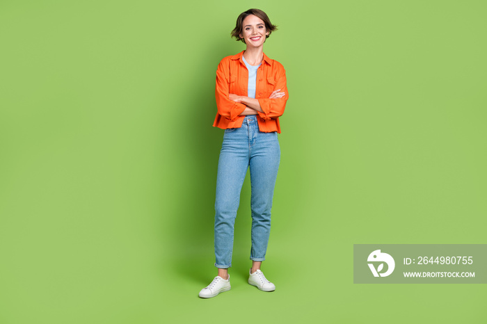 Full length photo of shiny adorable woman wear denim jacket smiling arms crossed isolated green color background