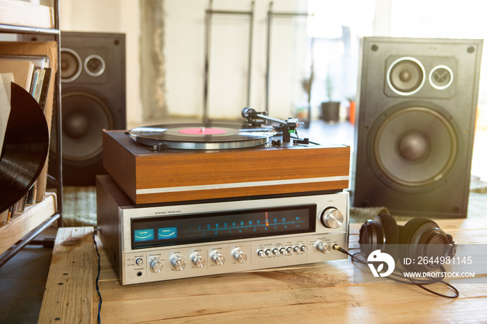 HiFi system with turntable, amplifier, headphones and lp vinyl records in a listening room