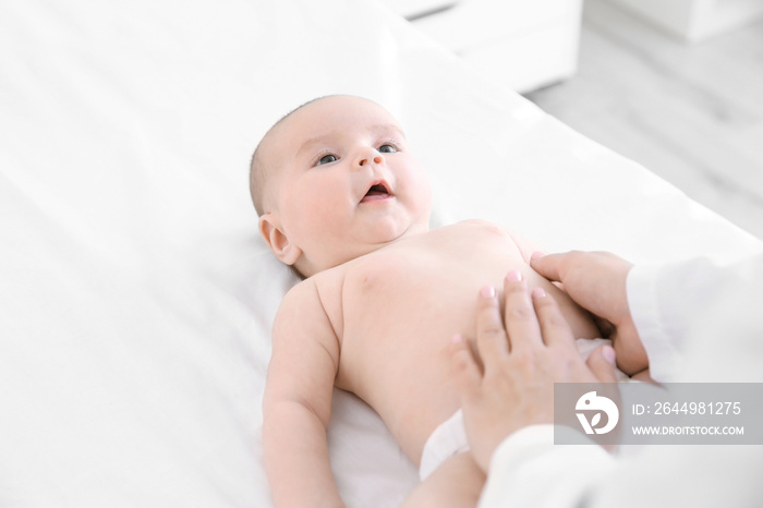 Doctor examining little baby in clinic. Baby health concept