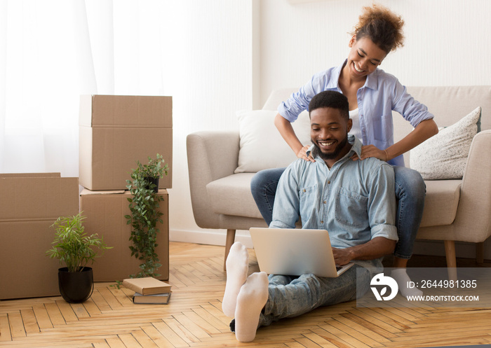 Afro Spouses Using Laptop Relaxing At Home After Relocation