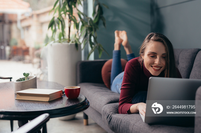 woman sitting at home and using laptop computer