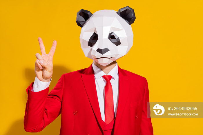 Photo of friendly confident guy mascot show v-sign wear panda head red tux isolated on yellow color background