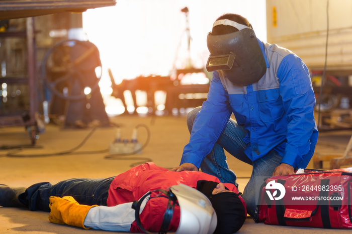 First aid training in the factory industrial. Welder accident in works and fainting in a factory industrial.