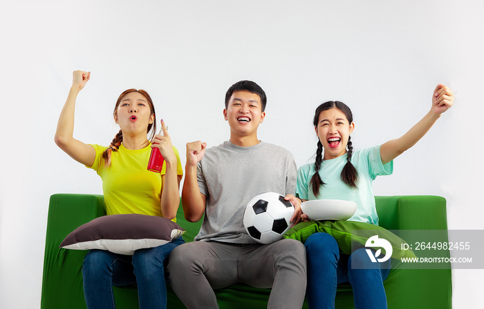 Happy asian friends or football fans watching soccer on tv and cheering at home. Friendship, sports and entertainment concept.