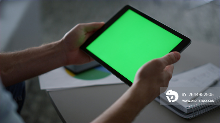 Man hands using tablet device green screen research business finance in office.