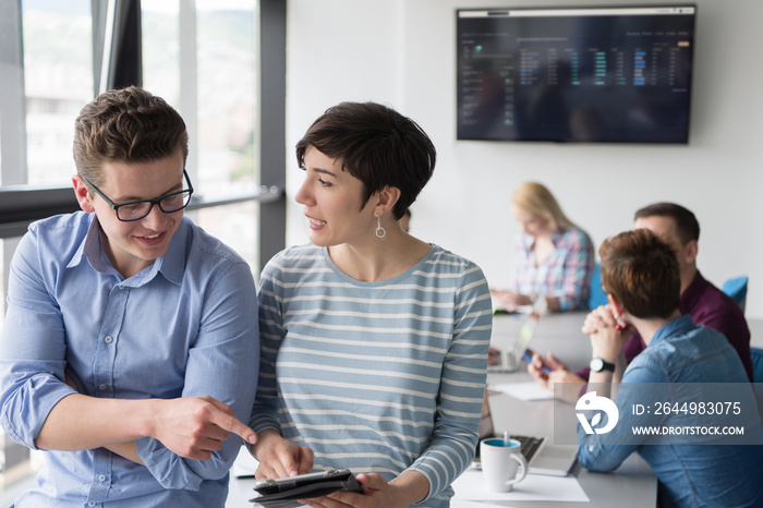 Two Business People Working With Tablet in office