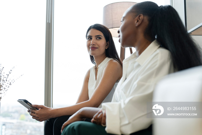 Businesswomen having meeting in office lobby