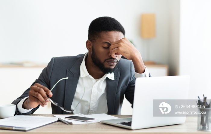 Overworked african american employee after hard day in office