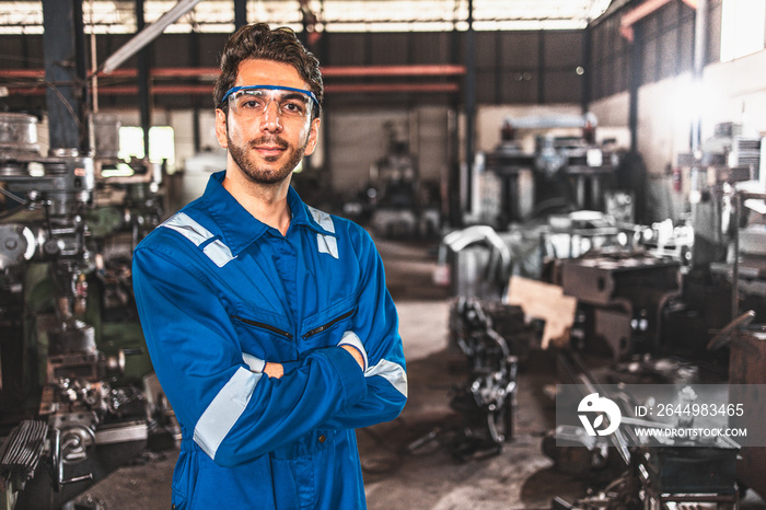 Young people worker in protective uniform operating machine at factory Industrial.People working in industry.Portrait of Female Engineer looking camera at work place.