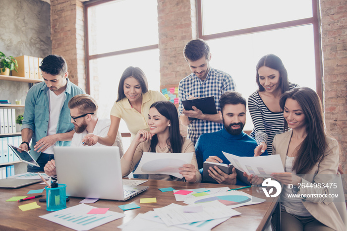 Team building concept. Close up of meeting of colleagues, all of them are  in casual clothes, discussing the company`s development strategy at nice cozy  office