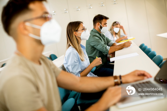 Female student wearing face protective medical mask for virus protection at lecture hall