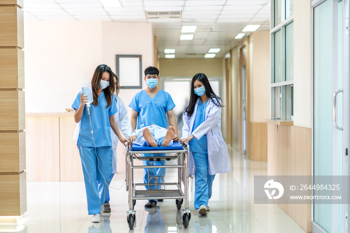 Group of professional medical doctor team and assistant with stethoscope in uniform taking seriously injured coma patient to operation emergency theatre room in hospital.health medical care concept