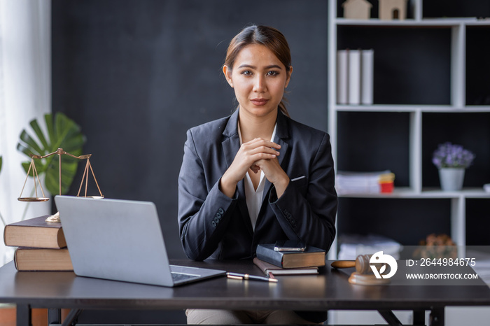 Attractive lawyer in office Business woman and lawyers discussing contract papers with brass scale on wooden desk in workplace. Law, legal services, advice, Justice and real estate concept.