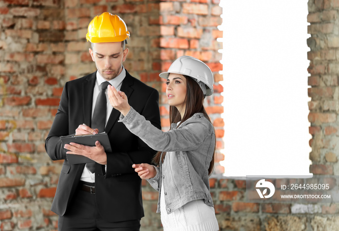 Insurance adjuster and young woman in abandoned building