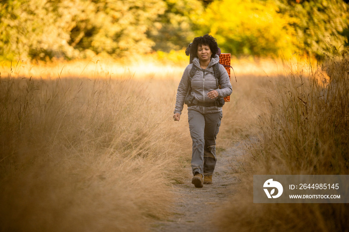 U.S. Army female soldier putting in the miles with an early morning hike in the NorthWest.