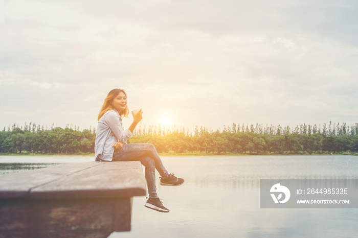 Young beautiful hipster woman holding coffee cup sitting on the